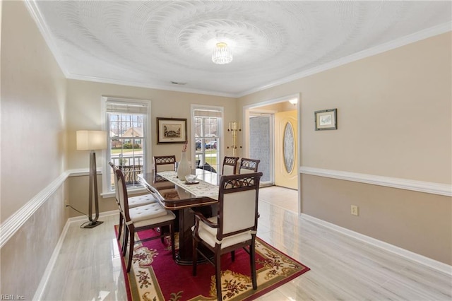 dining room with ornamental molding and light wood-type flooring