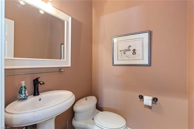 bathroom featuring toilet and sink