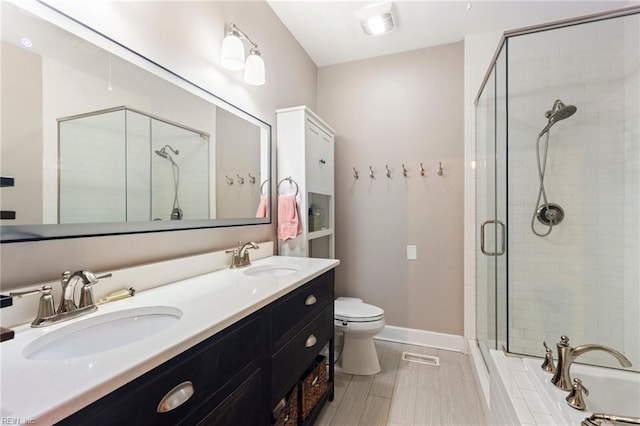 full bathroom featuring vanity, separate shower and tub, and toilet