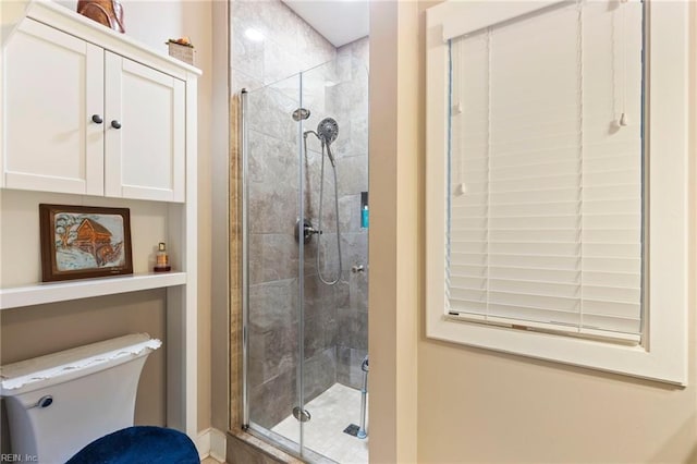 bathroom featuring toilet and walk in shower