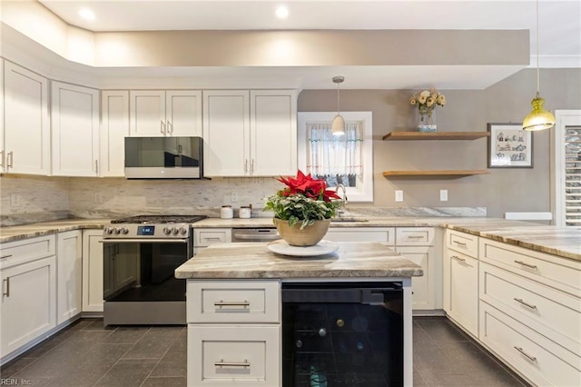 kitchen featuring decorative light fixtures, dark tile patterned flooring, wine cooler, stainless steel appliances, and light stone countertops