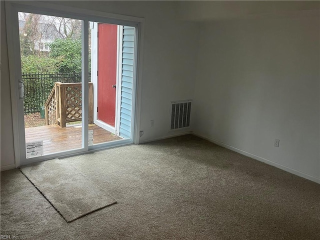 spare room with plenty of natural light and carpet