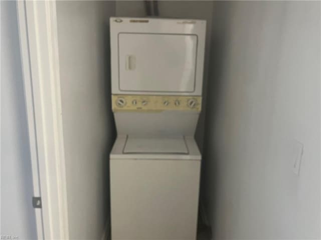 laundry room with stacked washer and dryer