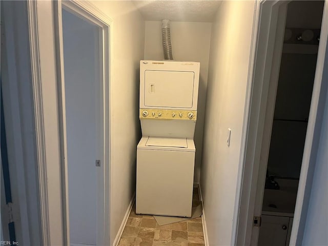 laundry room with stacked washer / dryer