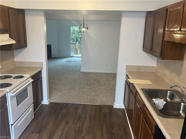 kitchen featuring extractor fan, pendant lighting, white range with electric stovetop, sink, and dark carpet