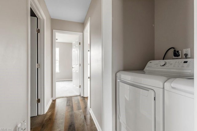 laundry area featuring washing machine and dryer and dark wood-type flooring