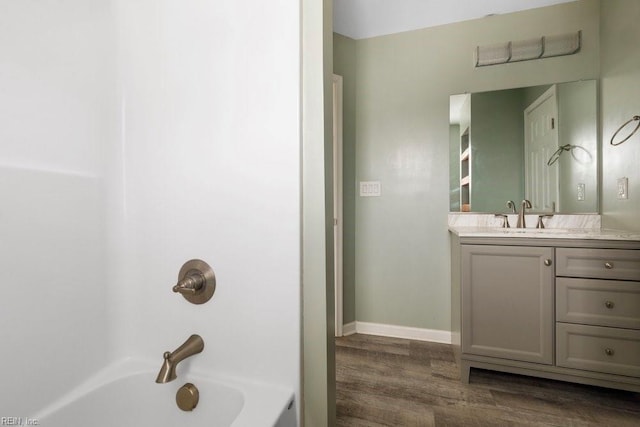 bathroom featuring vanity, wood-type flooring, and shower / bathtub combination