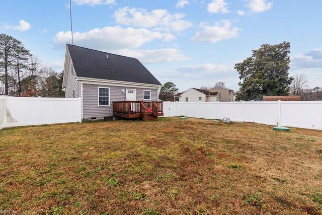 rear view of house featuring a wooden deck and a yard