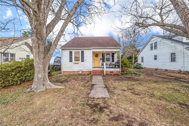 bungalow with a front yard and covered porch