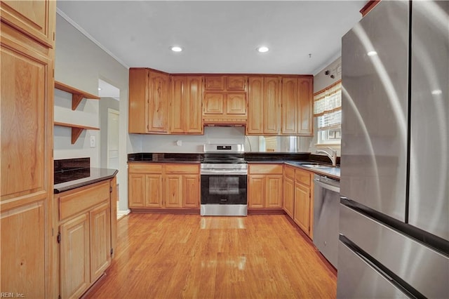 kitchen with ornamental molding, appliances with stainless steel finishes, sink, and light hardwood / wood-style floors