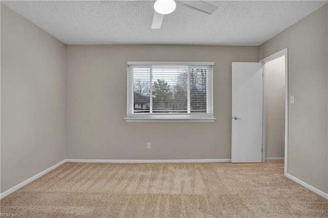 unfurnished room featuring light carpet, a textured ceiling, and ceiling fan