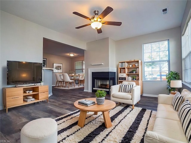 living room with dark hardwood / wood-style floors and ceiling fan