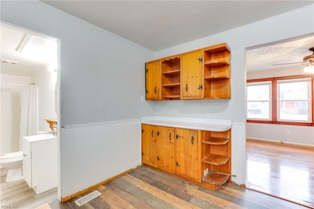 kitchen with hardwood / wood-style flooring and ceiling fan