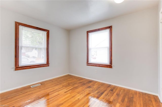 unfurnished room with wood-type flooring