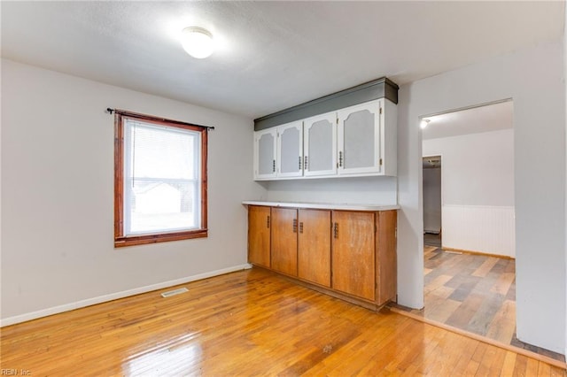 kitchen with white cabinetry and light wood-type flooring