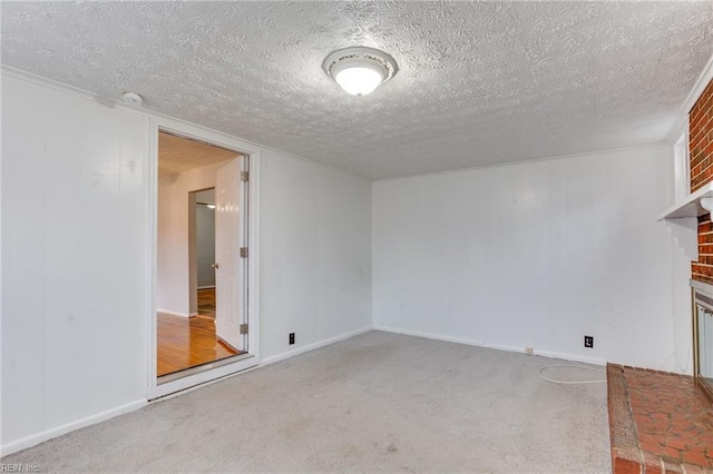 interior space with a brick fireplace, light colored carpet, and a textured ceiling