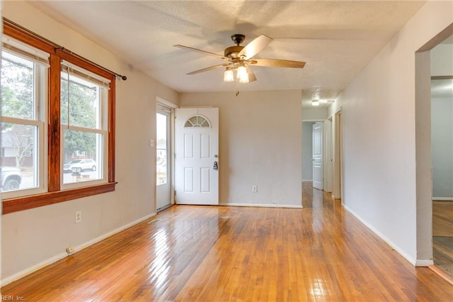 empty room featuring ceiling fan and light hardwood / wood-style floors