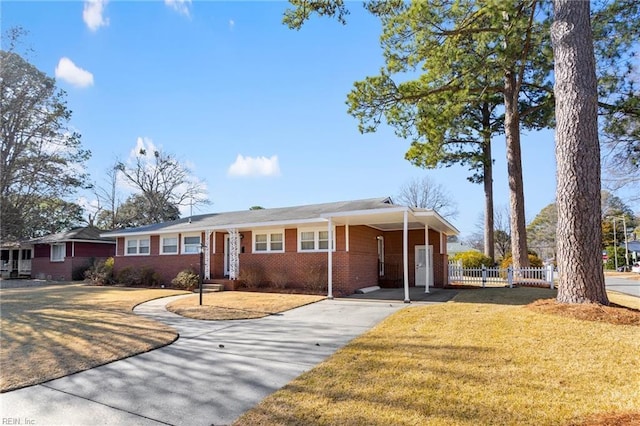 single story home featuring a front lawn and a carport