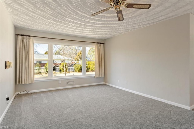 spare room with carpet and ceiling fan