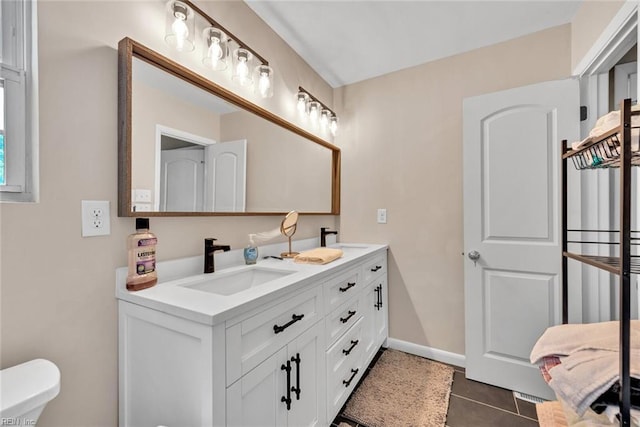 bathroom with tile patterned floors, vanity, and toilet