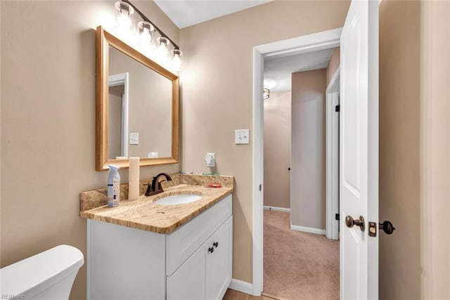 bathroom with vanity and toilet