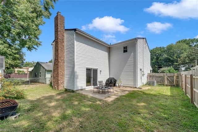 rear view of house with a patio and a yard