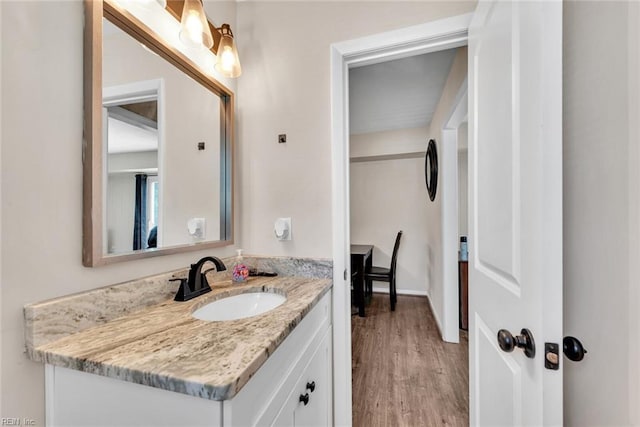 bathroom with hardwood / wood-style flooring and vanity