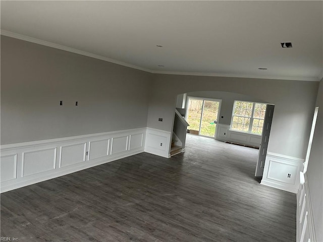 unfurnished room featuring ornamental molding and dark hardwood / wood-style floors