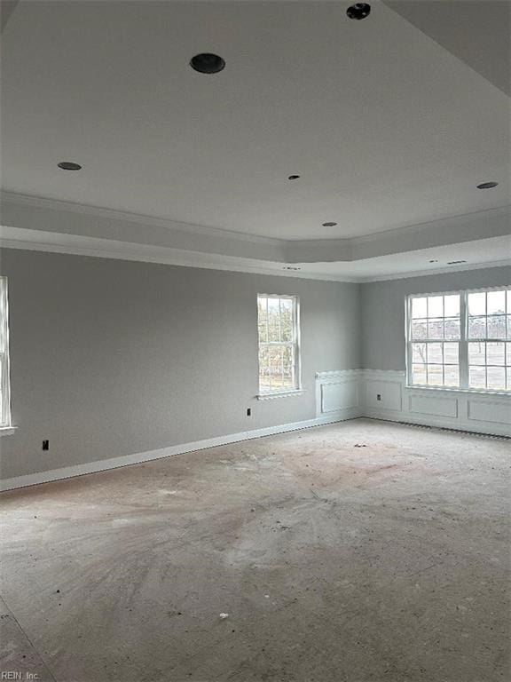 unfurnished room featuring a tray ceiling