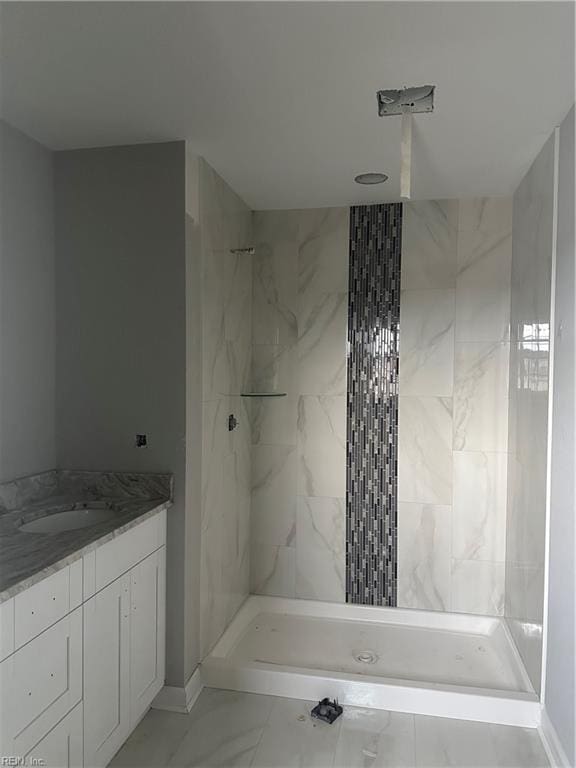 bathroom featuring vanity and tiled shower