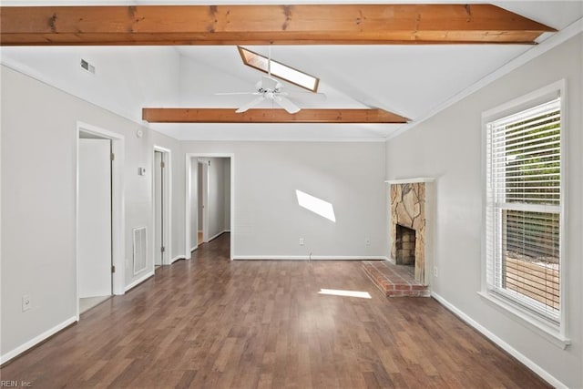 unfurnished living room with vaulted ceiling with beams, a stone fireplace, dark hardwood / wood-style floors, and ceiling fan