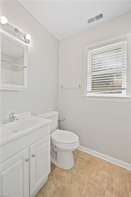 bathroom featuring tile patterned flooring, vanity, and toilet