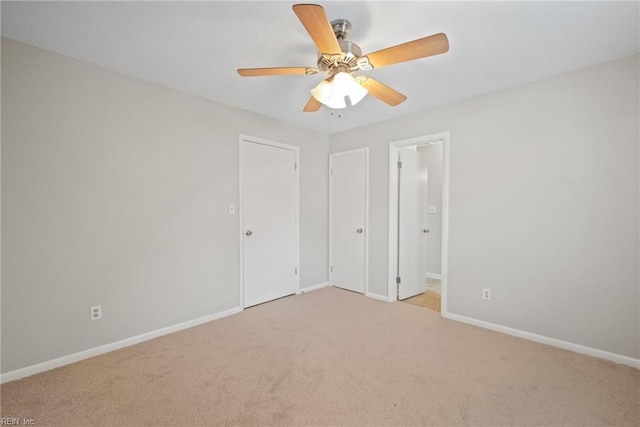 unfurnished bedroom with light colored carpet and ceiling fan