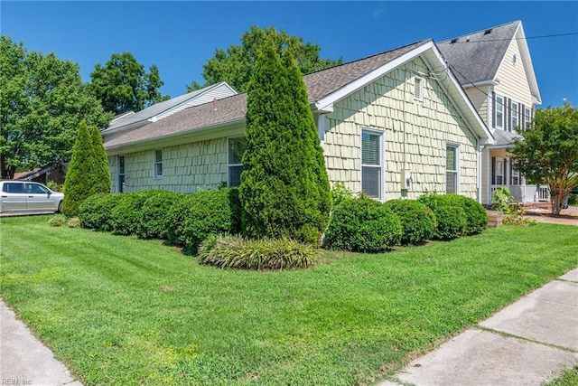 view of side of home featuring a lawn