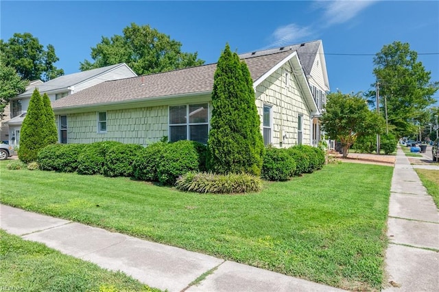 view of side of property with a yard