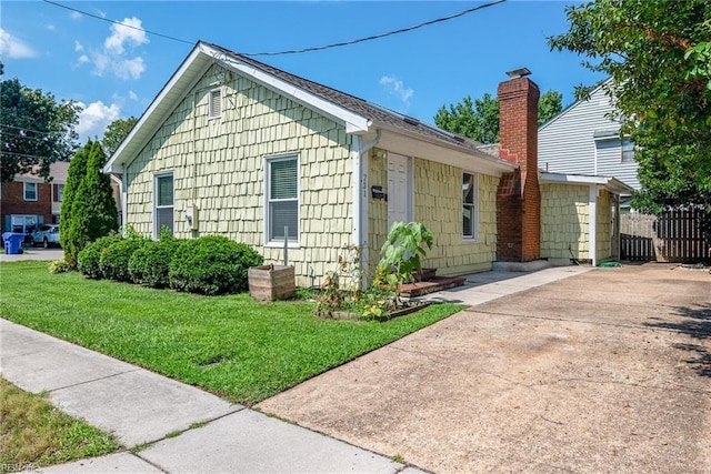 view of side of home with a lawn