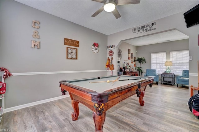 recreation room featuring pool table, light hardwood / wood-style floors, ceiling fan, and a textured ceiling