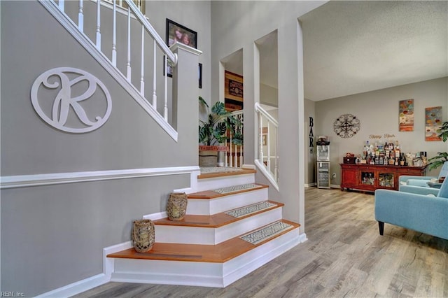 staircase with wood-type flooring