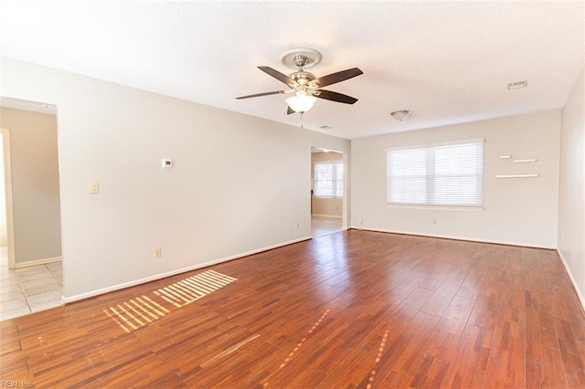 spare room featuring hardwood / wood-style floors, a textured ceiling, and ceiling fan