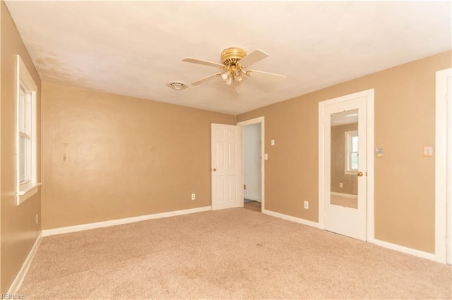 2228 Kings Hwy, Suffolk, VA 23435 - spare room with visible vents, baseboards, light colored carpet, and a ceiling fan