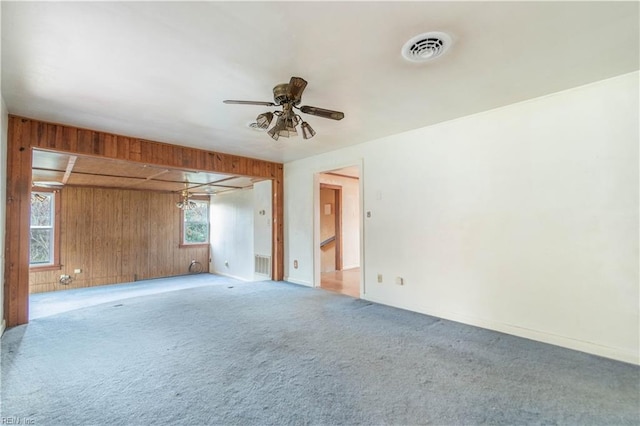 2228 Kings Hwy, Suffolk, VA 23435 - carpeted empty room with ceiling fan, visible vents, and wood walls