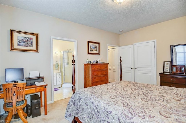 bedroom with ensuite bath and a textured ceiling