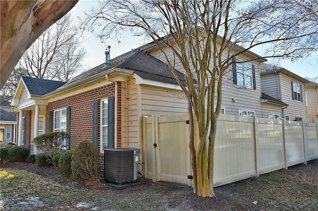 view of side of home with central AC