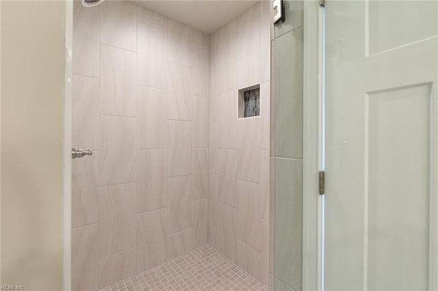 bathroom with a tile shower