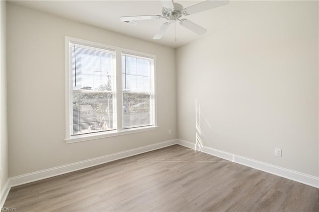 spare room featuring ceiling fan and light hardwood / wood-style floors