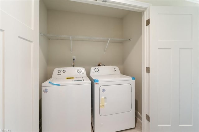 clothes washing area with washing machine and dryer