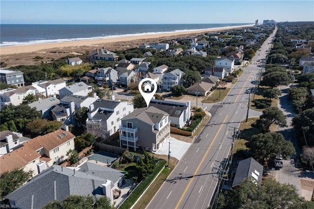 bird's eye view featuring a water view and a beach view