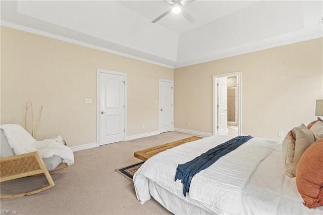 carpeted bedroom with crown molding, ceiling fan, and a raised ceiling