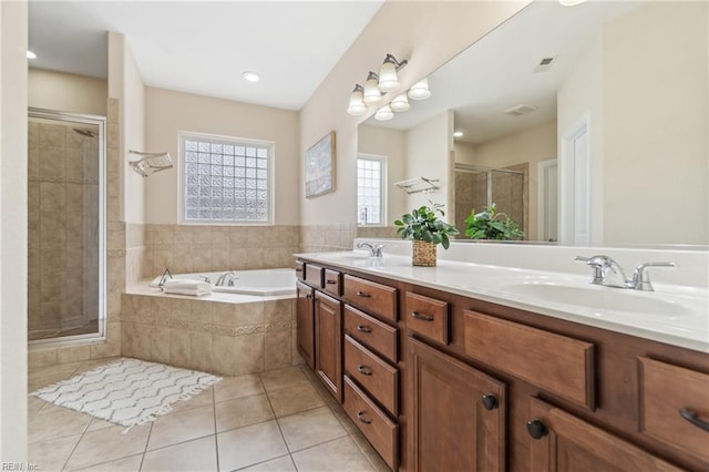 bathroom featuring tile patterned floors, independent shower and bath, and vanity