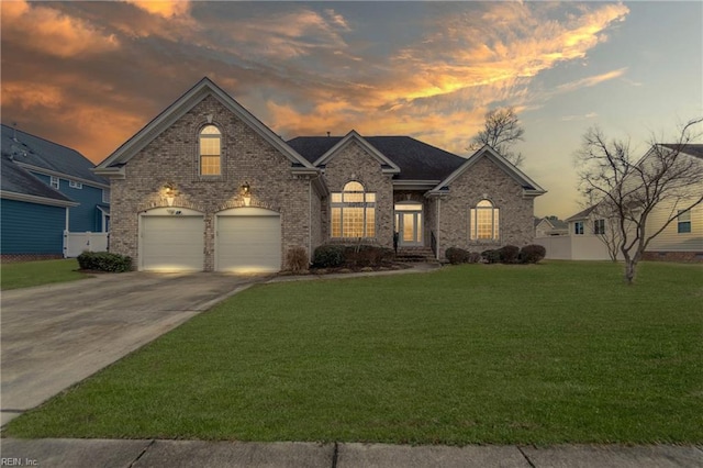 french country style house featuring a garage and a lawn